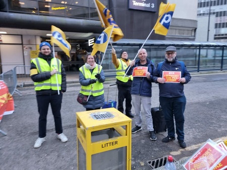 3 PCS members with PCS flags and two men holding I SUPPORT THE STRIKE cards