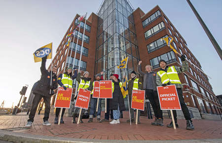 PCS members with OFFICIAL PICKET placard outside Wales Senedd building