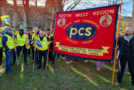 Photo shows group of PCS members holding large PCS SOUTH WEST REGION fabric banner