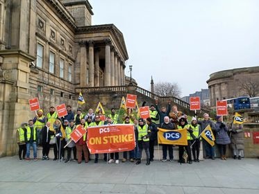 Photo shows a large group of PCS pickets by the entrance to the World Museum Liverpool