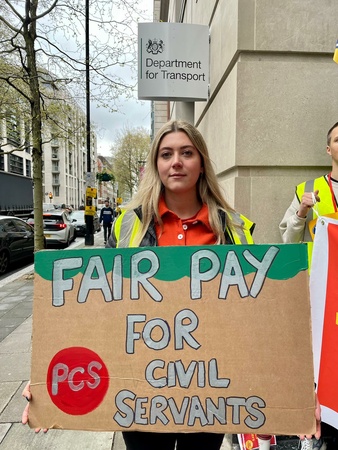 Jocelyn outside the Department for Transport has a placard with a powerful message: fair pay for civil servants