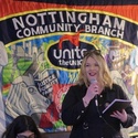 The image shows Dani Jackson stood in front of a trade union banner