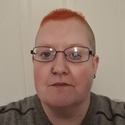 Ruth has very short, red hair and is wearing glasses