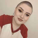 Em has very short hair and winged eye make-up