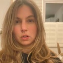 The photo shows PCS activists Athene Dilke who has long hair and is wearing a black top